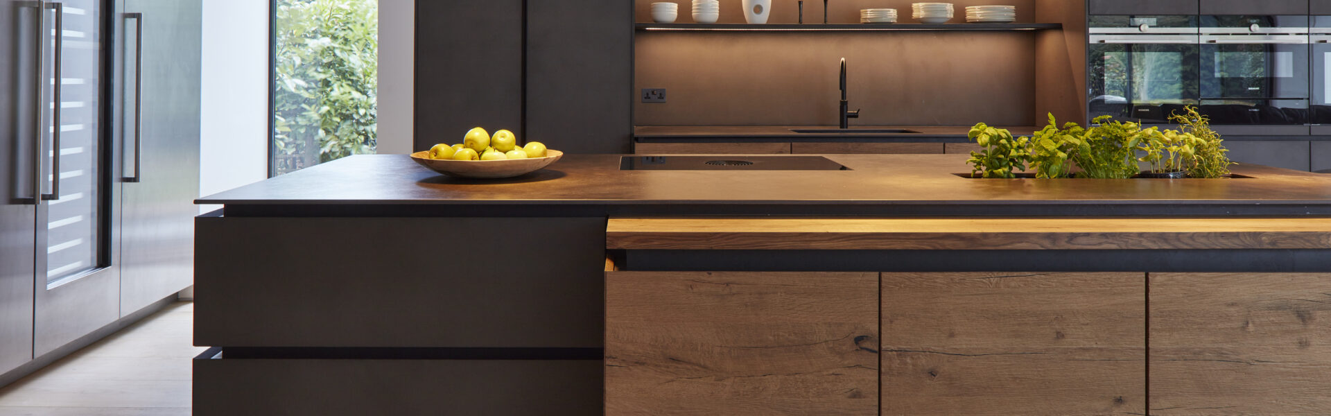 Grey and timber kitchen with inbuilt herb garden in the island
