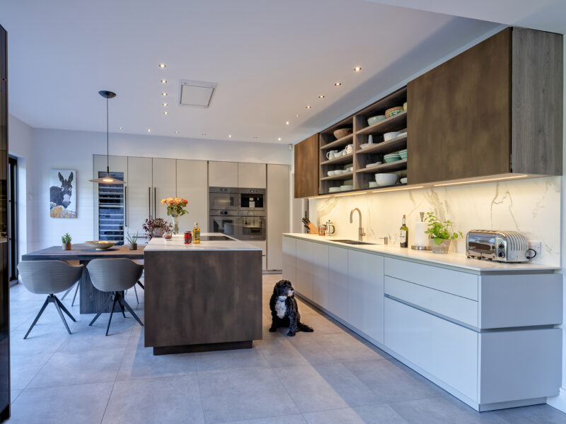 Open plan kitchen diner room with island and open crockery storage