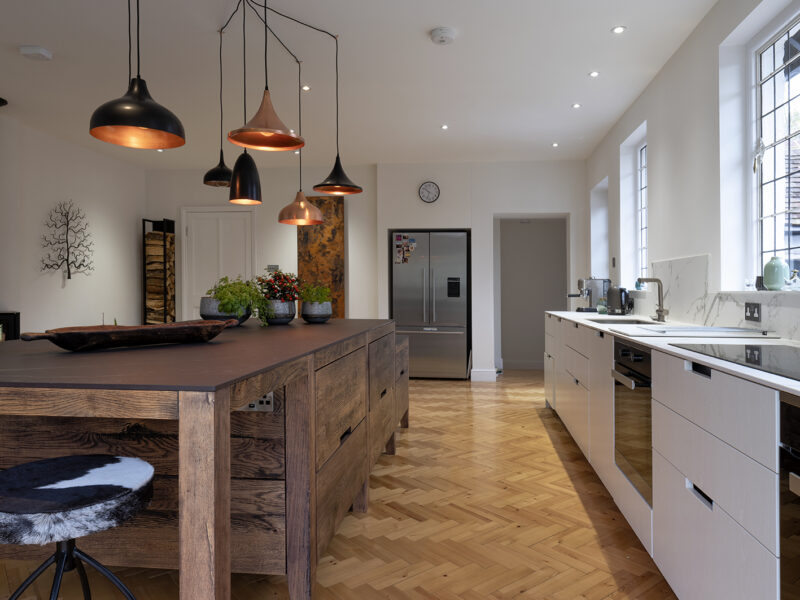 Large kitchen design with herringbone flooring and kitchen islands