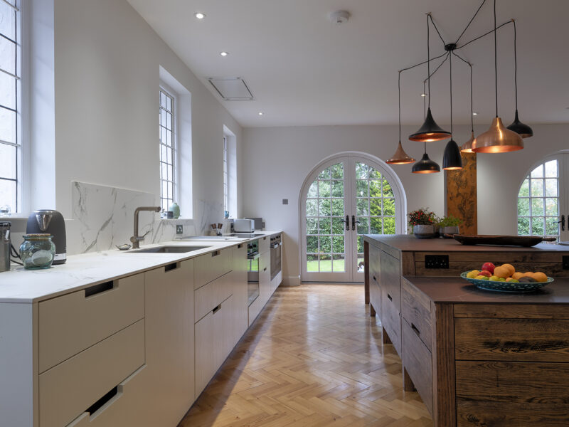 Large kitchen design with herringbone flooring and kitchen islands