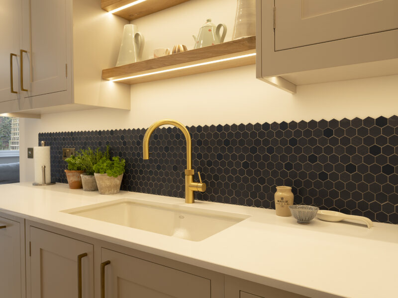 Kitchen hexagonal back splash with gold taps