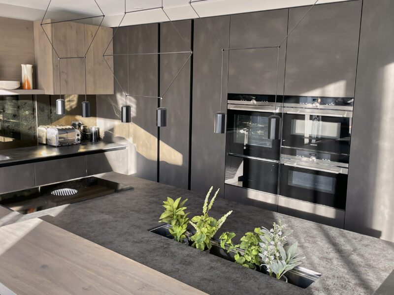 brand new bespoke kitchen with plants in the island