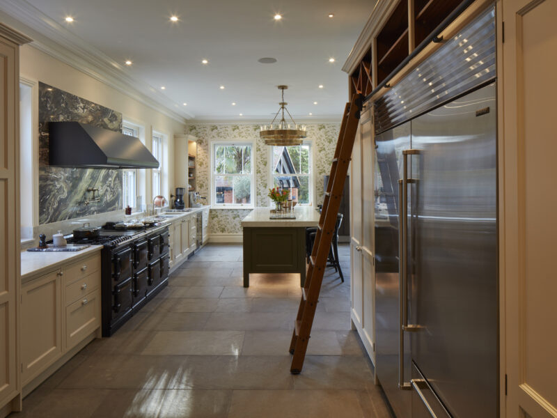 modern kitchen with a reclaimed oak island, ladder, and refrigerator
