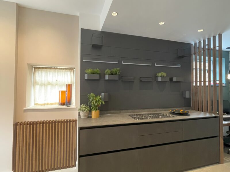 modern kitchen with dark cabinets and flower vases