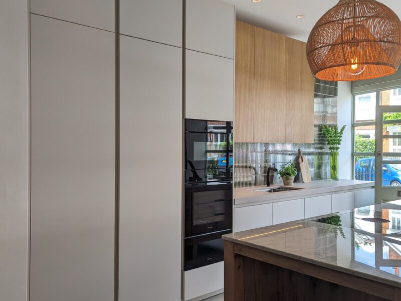 Contemporary kitchen with white cabinetry